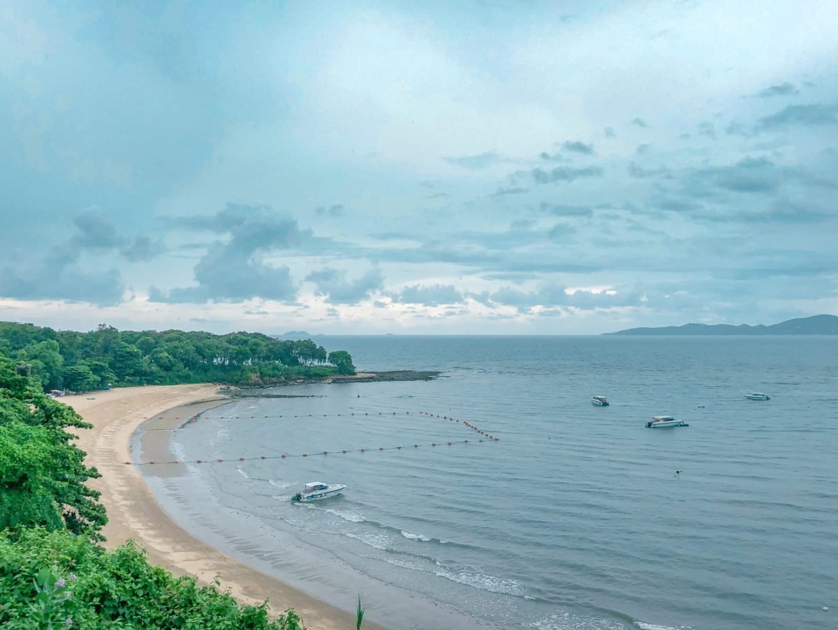 beautiful-shot-beach-shore-with-boats-water-blue-cloudy-sky