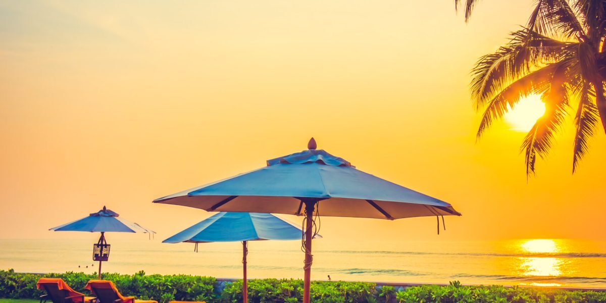 Empty umbrella and chair on the beach at Twilight Times - Vintage Filter